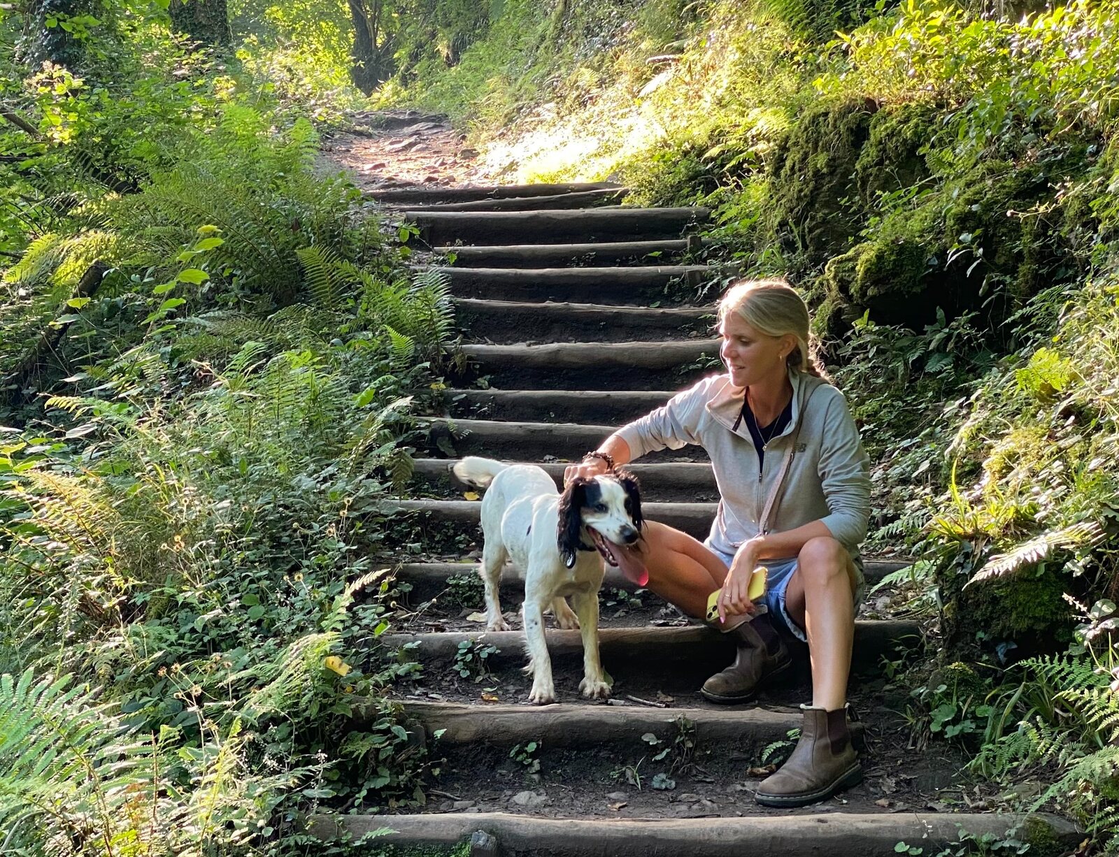 Rebecca and Bobbie resting together on woodland steps